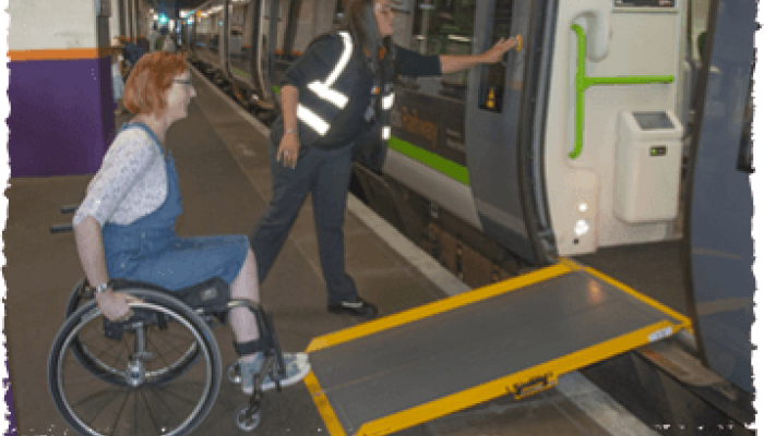 Passenger being assisted onto a train