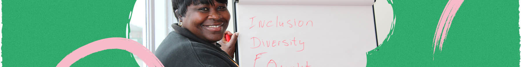 Black woman smiling in diversity and inclusion meeting.