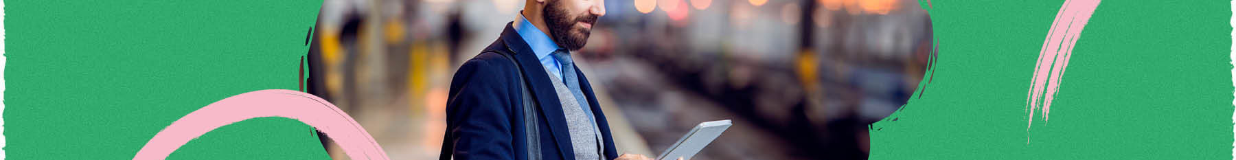 Business person viewing his phone on a train platform