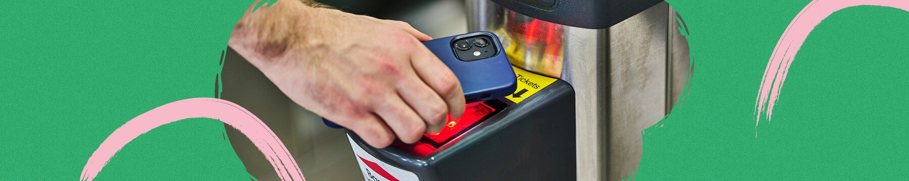 A person using their phone to go through a ticket barrier