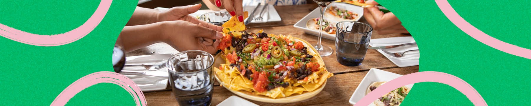 Close up of friends enjoying Mexican food at restaurant table