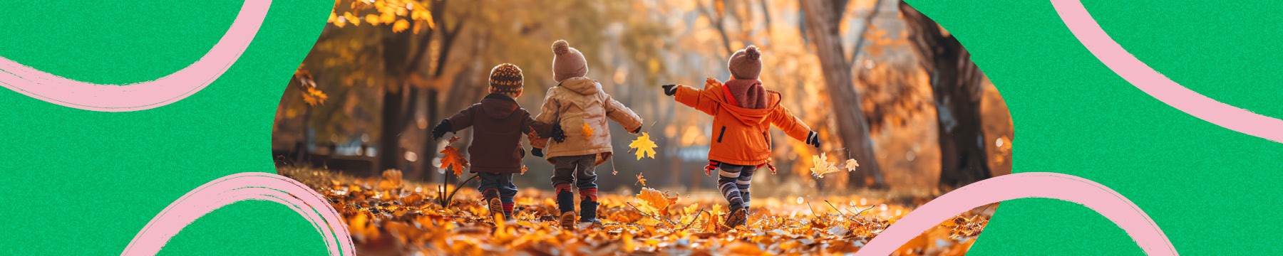 Three kids frolicking in a wooded area linking arms and tossing autumn foliage into the air