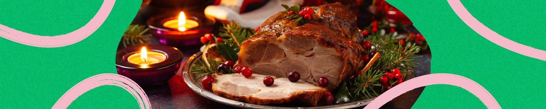 Roast pork neck in Christmas style Dark navy blue background Christmas accessories Candles and lanterns in the background 