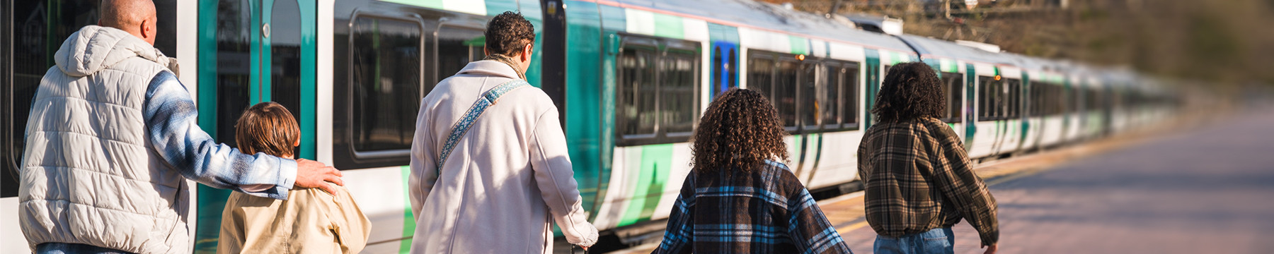 family boarding an LNR class 730 train