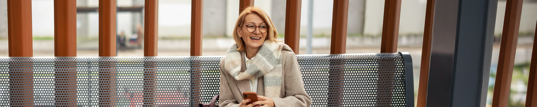 person with glasses at a train station