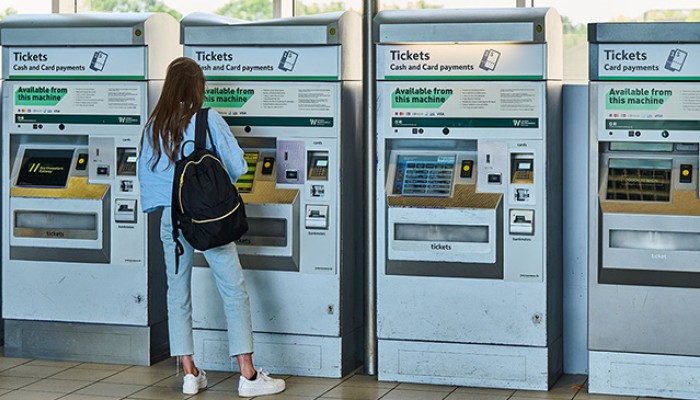Passenger buying tickets through a ticket vending machine.