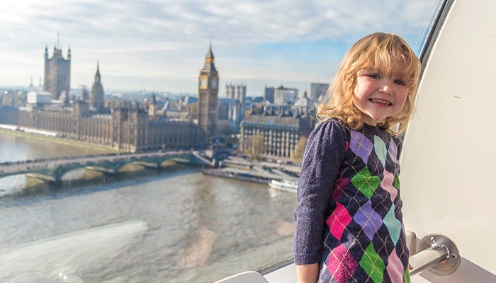 Child on the London Eye with the Houses of Parliament in the background