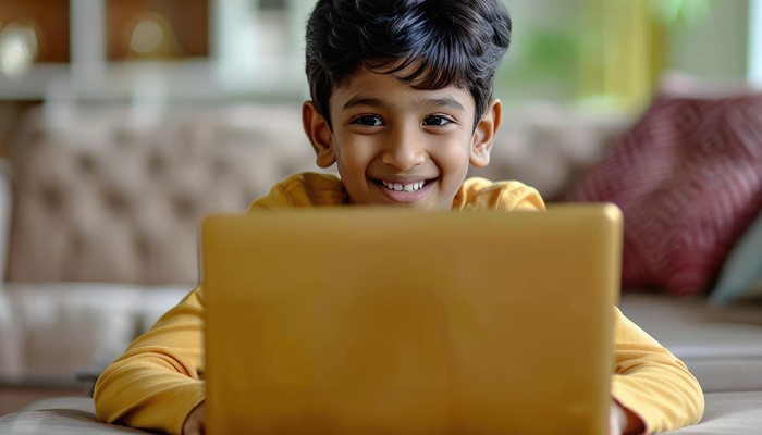 Child studying on laptop