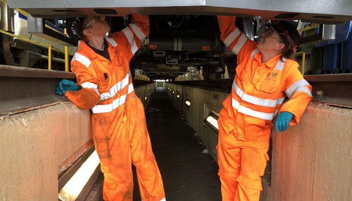 Engineering apprentices inspecting a train