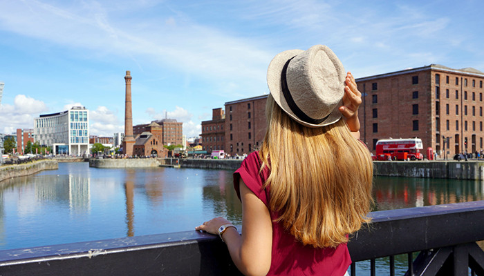 travelling girl looking out from Liverpool s swingers bridge over the dock