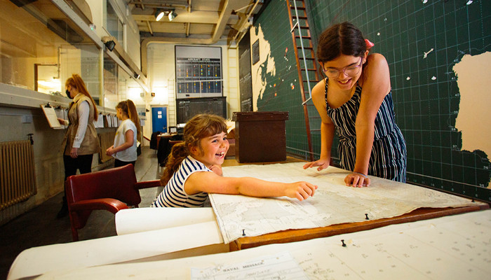 children in the map room at the western approaches museum in liverpool