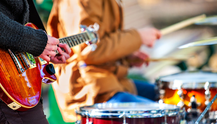 two people playing guitar and drums