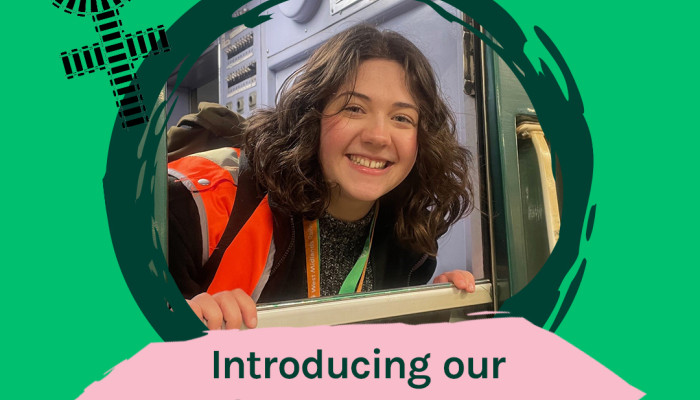 Introducing our Graduate programme image of Alex with the female symbol Circle atop a cross made of train tracks 