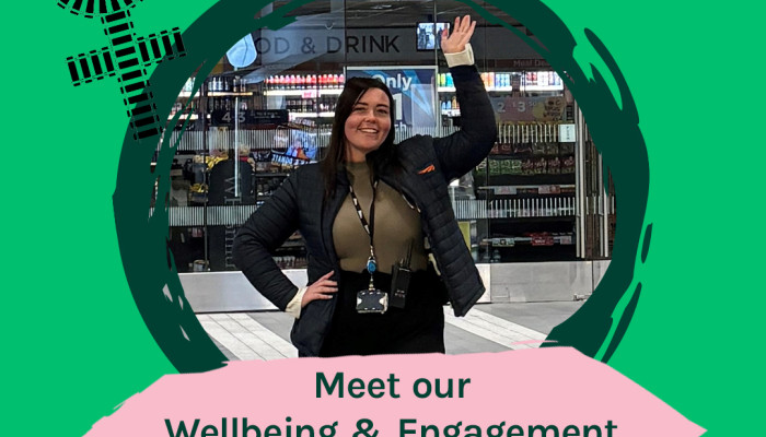 Learn about the role of Wellbeing Engagement Manager image of Dani with the female symbol Circle atop a cross made of train tracks 