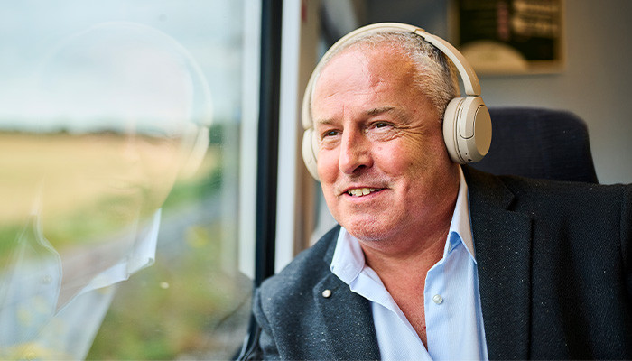 Passenger with headphones looking out the window