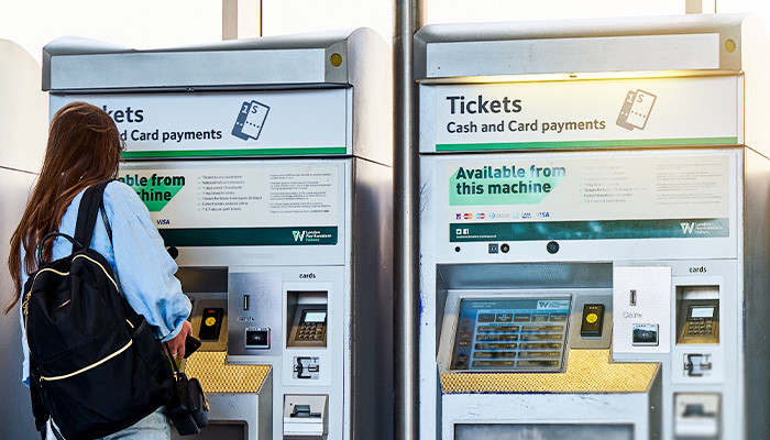 Passesnger using a ticket vending machine