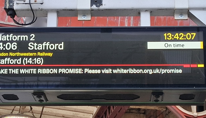 Information screen at Canley Station showing a prompt encouraging people to make the White Ribbon Pledge