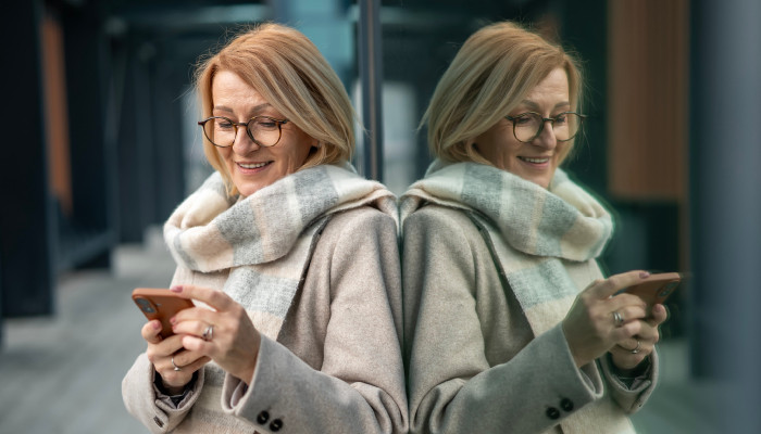 person with glasses at a train station