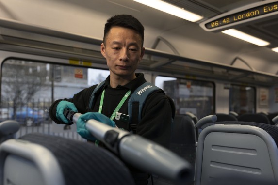 Cheng - train cleaner - sanitising a London Northwestern Railway train.