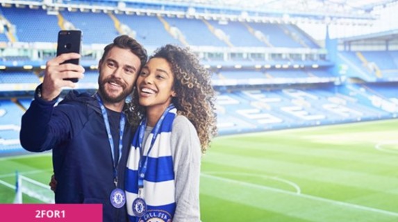 A man and a woman taking a selfie at Stamford Bridge.