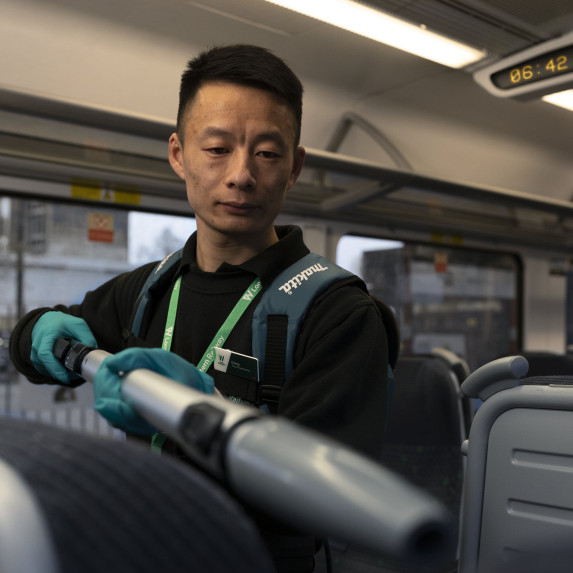 Cheng - train cleaner - sanitising a London Northwestern Railway train.