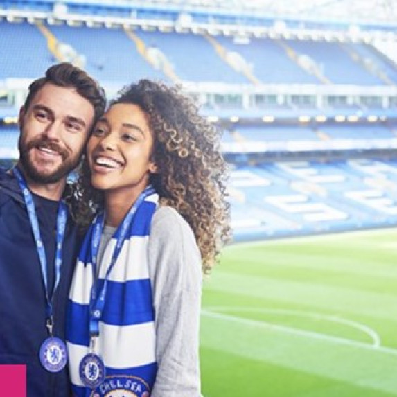A man and a woman taking a selfie at Stamford Bridge.