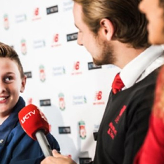 A young biy in Liverpool's press conference room.