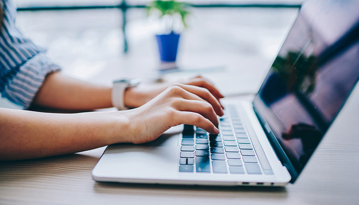 person typing on laptop