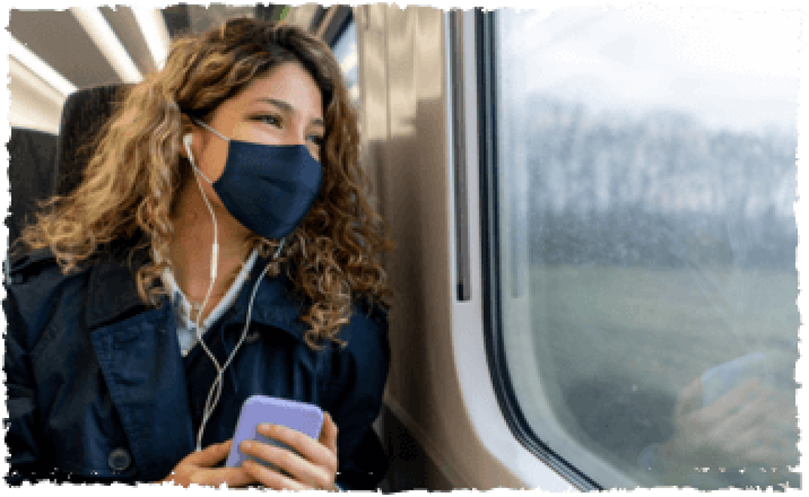 Passenger with a face covering on a train