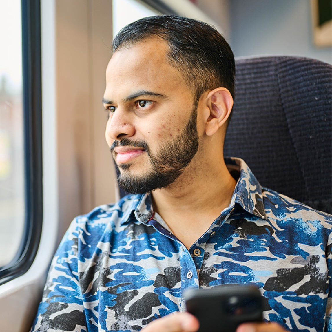 Passenger looking out a train window