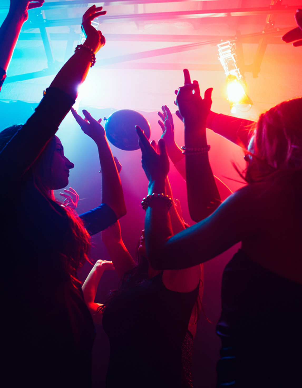 silhouettes of people dancing in a club
