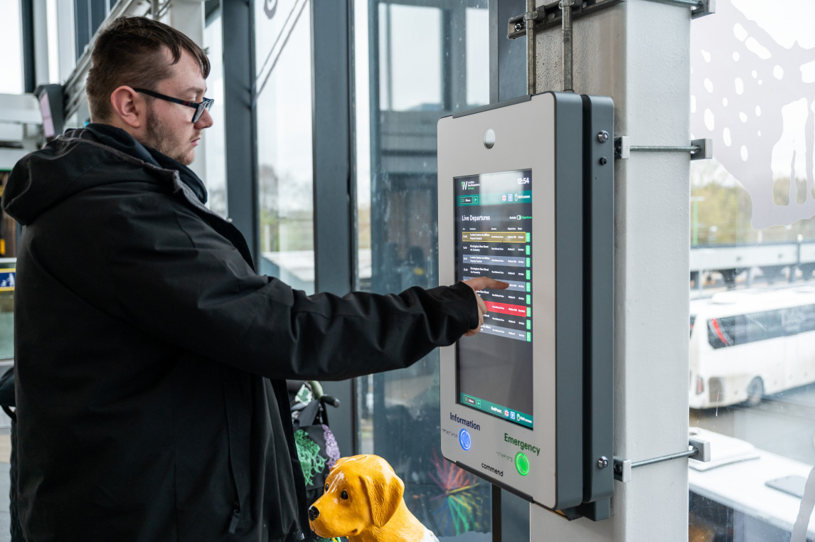 An image of a customer using a help point.